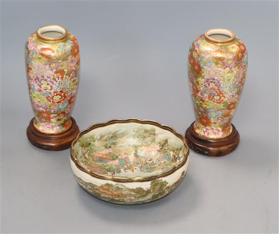 A Japanese Satsuma bowl and a pair of vases on stands
